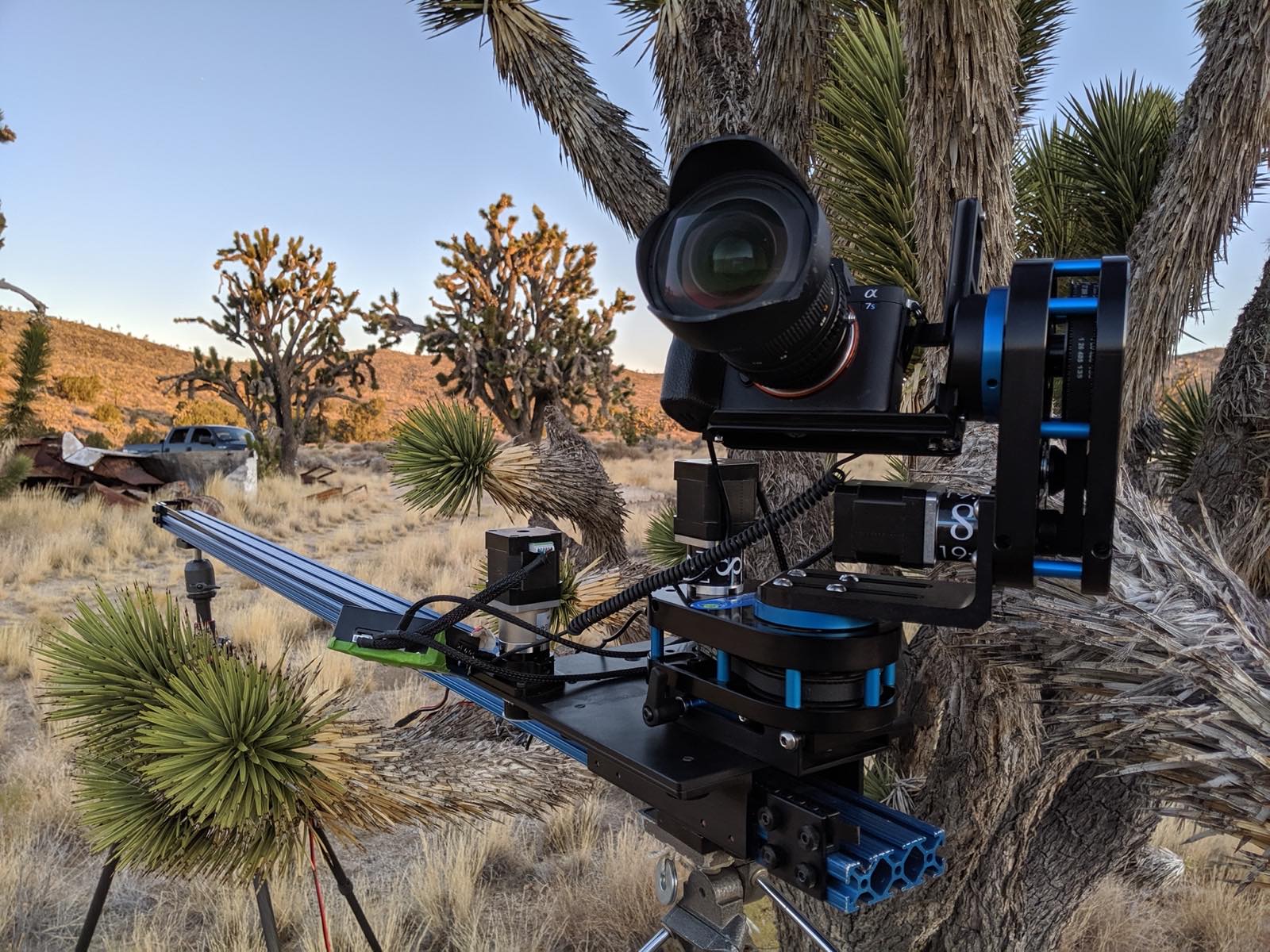 A Dynamic Perception NMX motion rig — slider, pan, and tilt with a mounted camera — set up for a timelapse at golden hour in the high desert